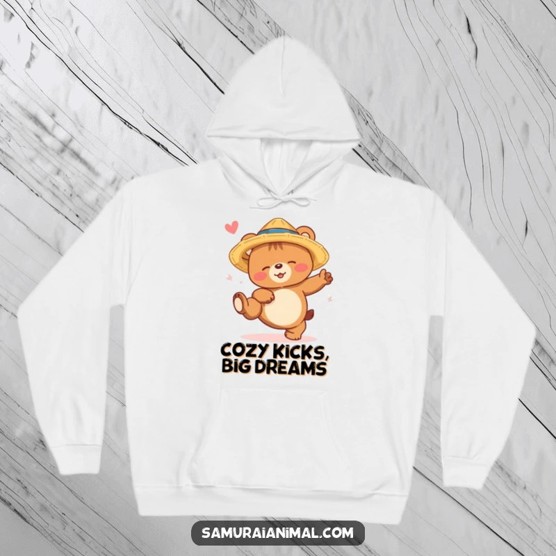 Funny bear cub hoodie featuring a smiling, sleepy bear in a straw hat, humorously attempting a high kick with cozy charm.