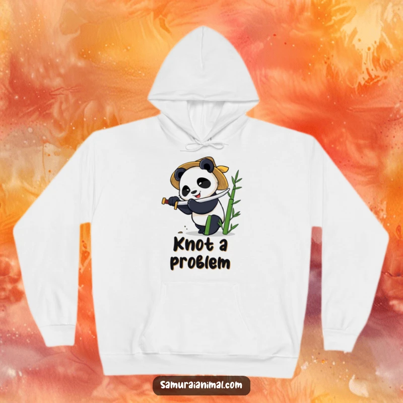 Funny hoodie with a smiling panda wearing a straw hat, wielding a tiny katana to chop bamboo with intensity.